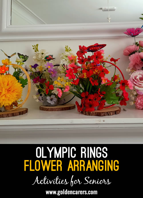 Create a vibrant and meaningful floral arrangement inspired by the Olympic rings, perfect for adding a touch of international spirit and color to any space.